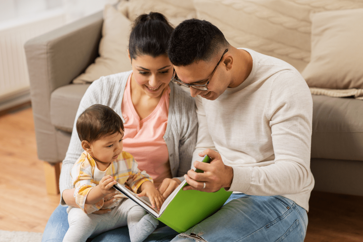 parents read green book to baby