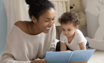Mom reads blue book to baby