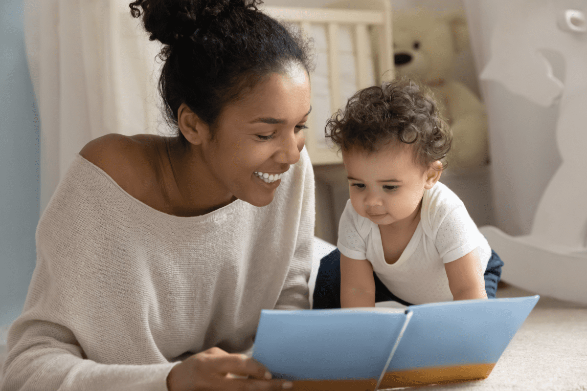 Mom reads blue book to baby