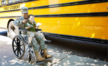 military dad in wheelchair holds child by school bus