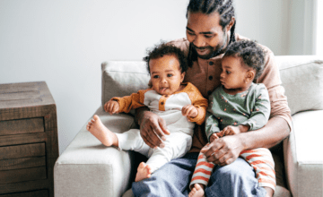 dad holds two children in his lap