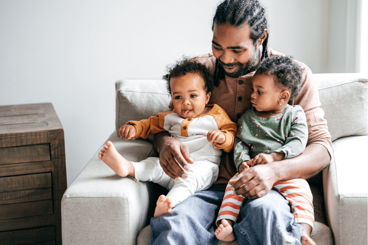 dad holds two children in his lap