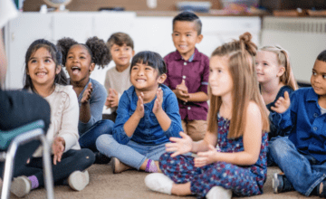 class of children sitting on floor