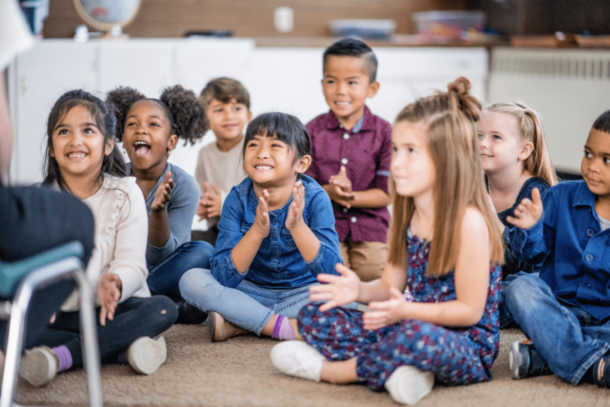 class of children sitting on floor