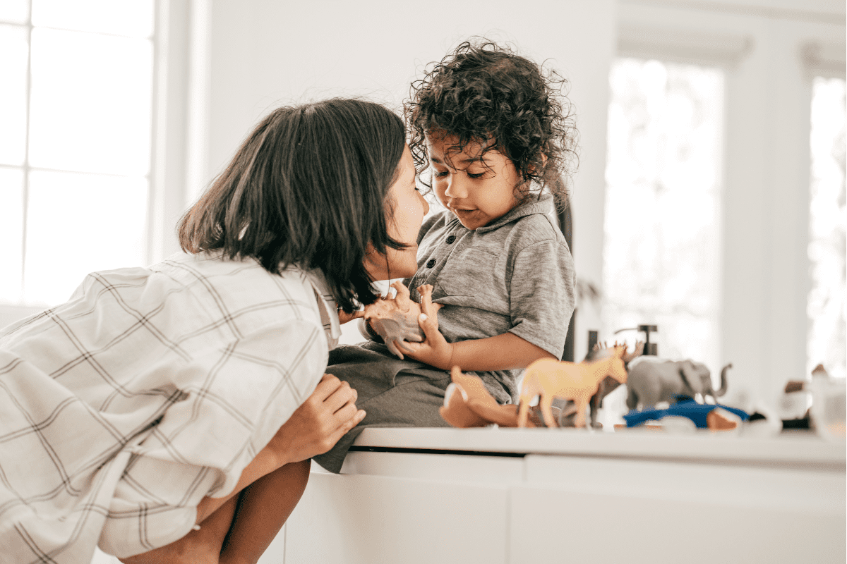 baby on counter mom leans in