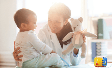 mom shows baby a teddy bear