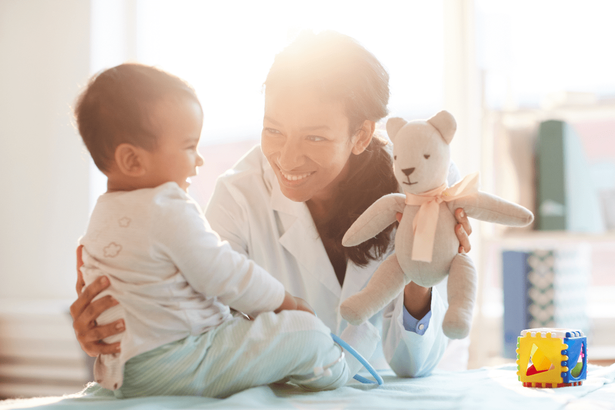 mom shows baby a teddy bear