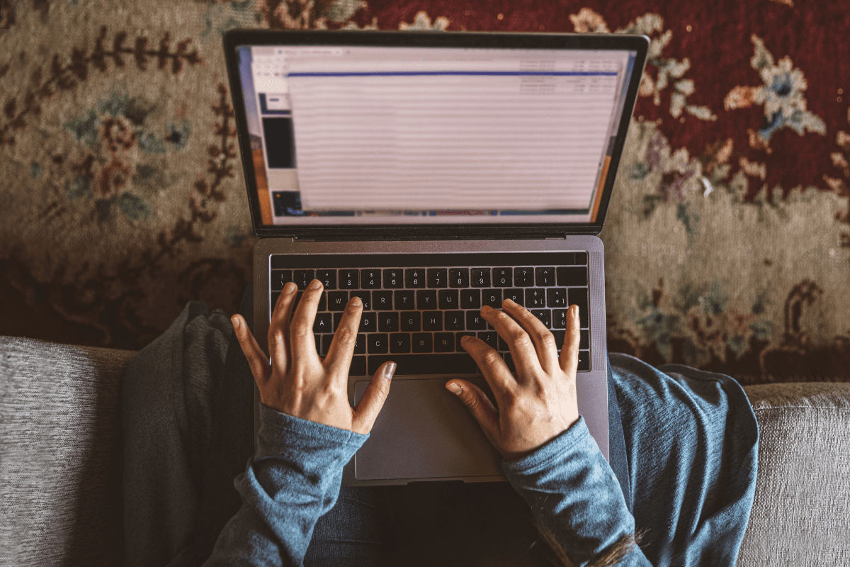 hands typing on a laptop