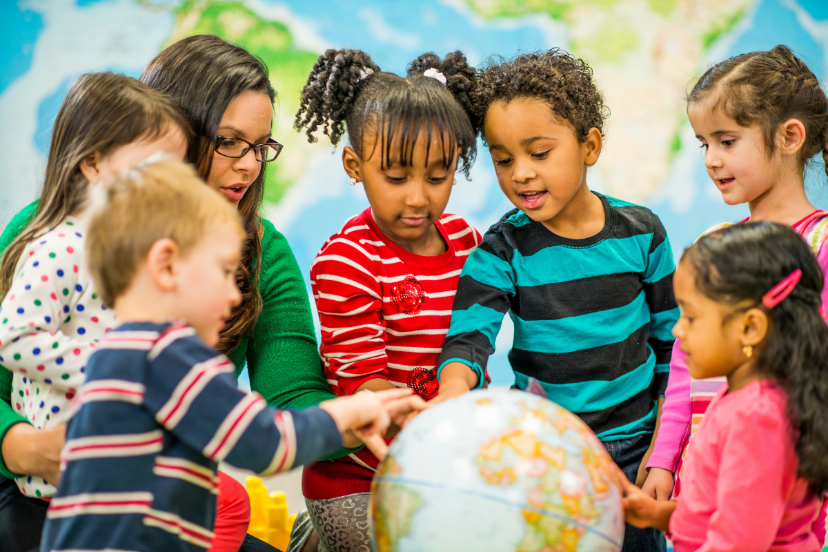 preschool kids touch a globe