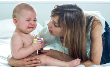 mom comforts crying baby