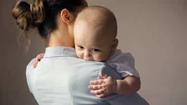 A woman holds a baby