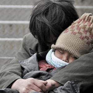 Parent and child holding each other wearing clothing for warmth