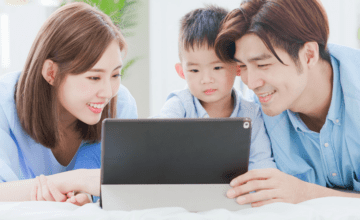 parents and son looking at tablet