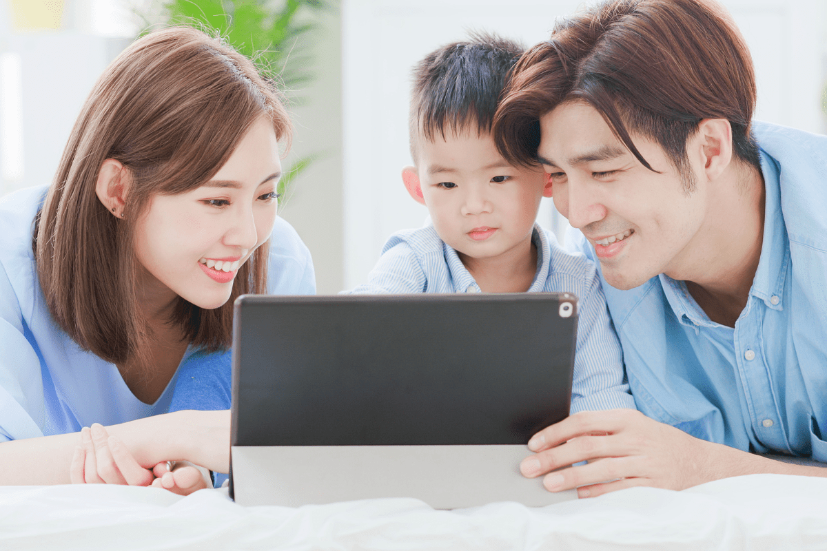 parents and son looking at tablet