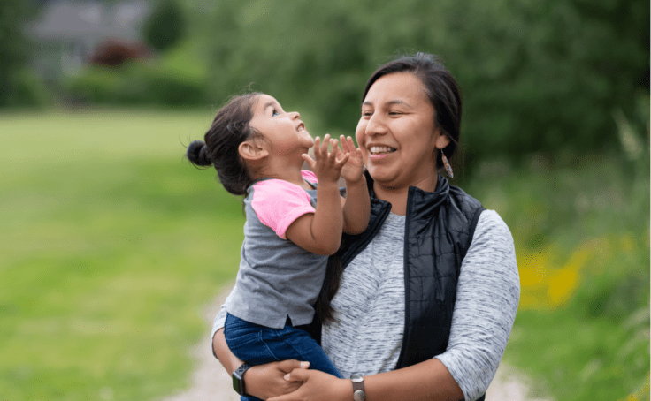 native american mother and daughter at park