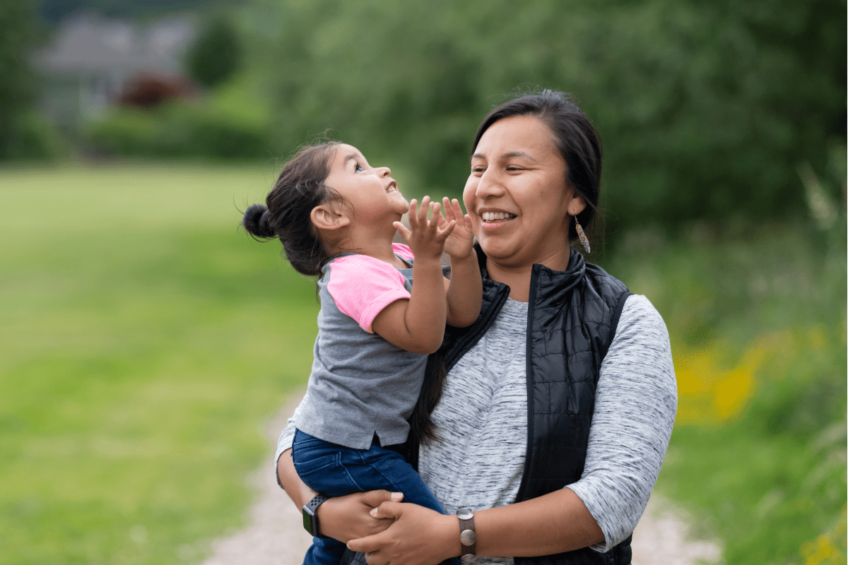 native american mother and daughter at park