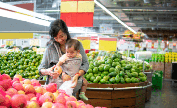 mom buys apples at grocery store