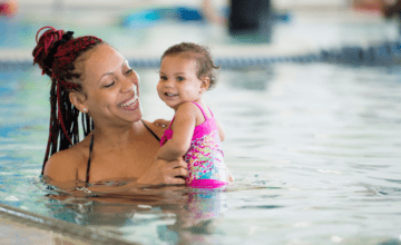 Mom swimming with infant