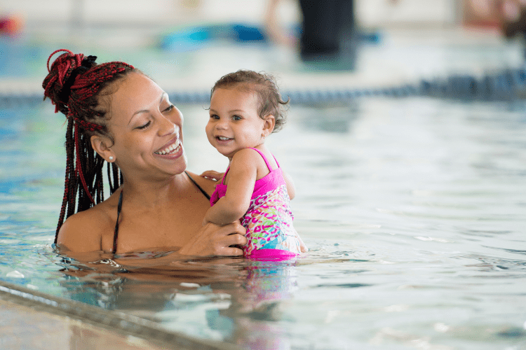 Mom swimming with infant