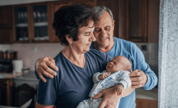 grandparents hold infant