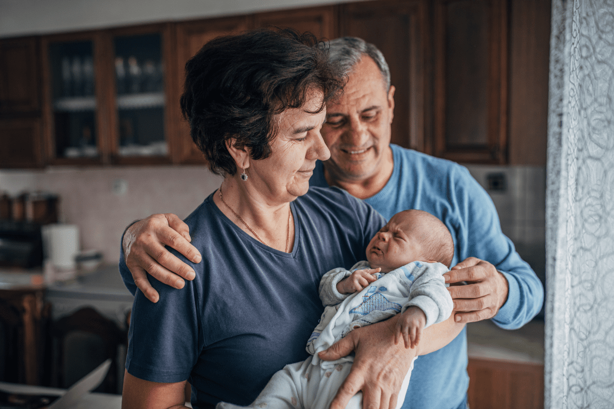 grandparents hold infant