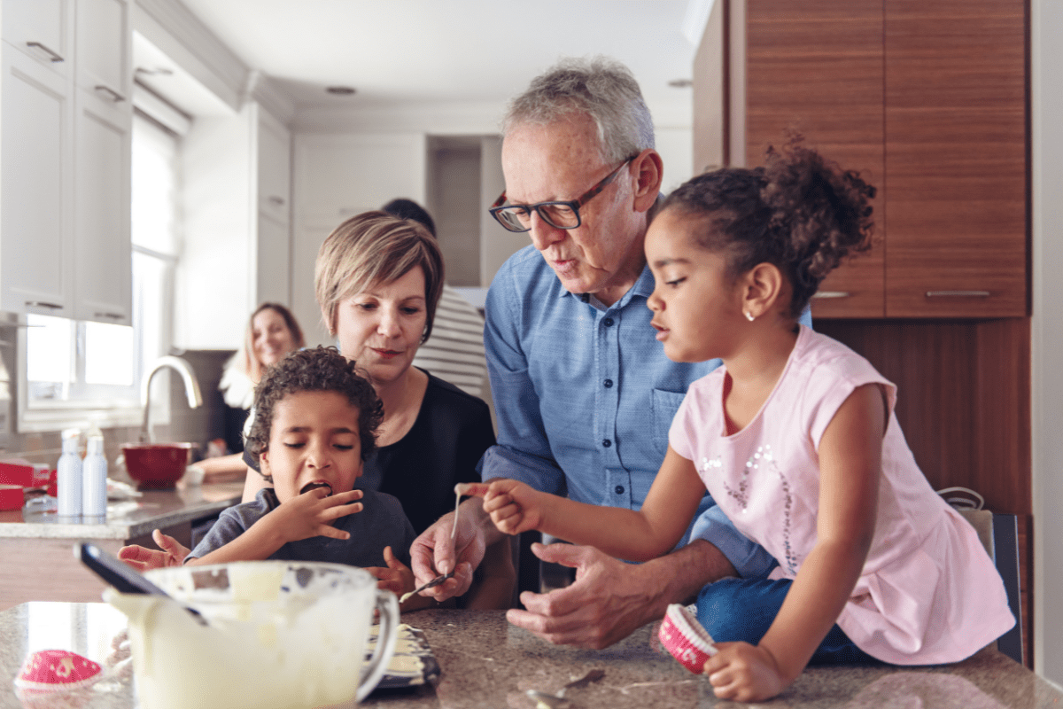 grandparents cook with grandkids, mixed family