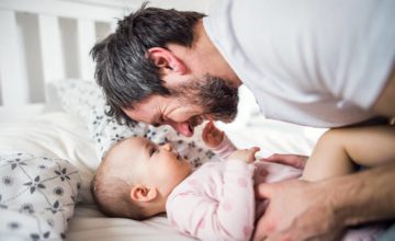 dad and baby smiling at each other