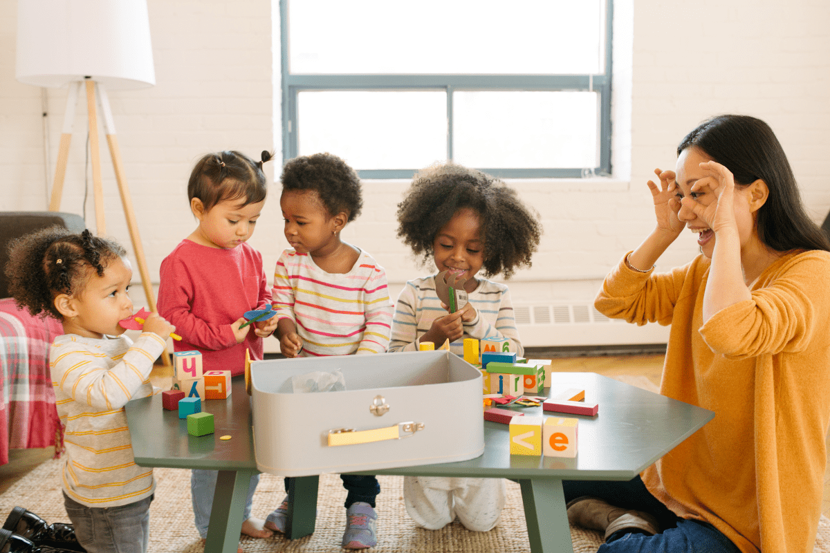 woman makes funny eyes at children