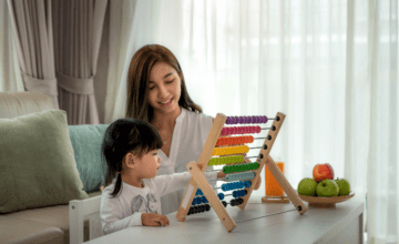 mom watches daughter use abacus