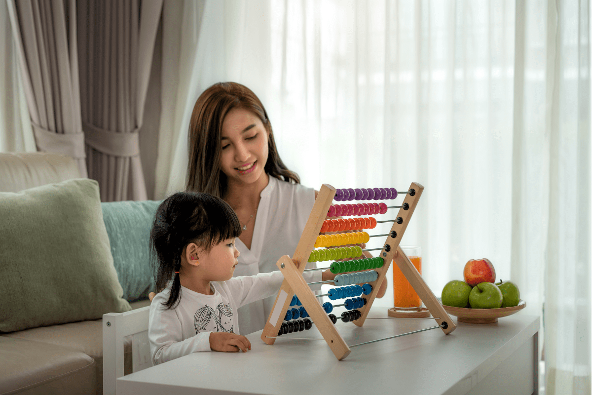 mom watches daughter use abacus