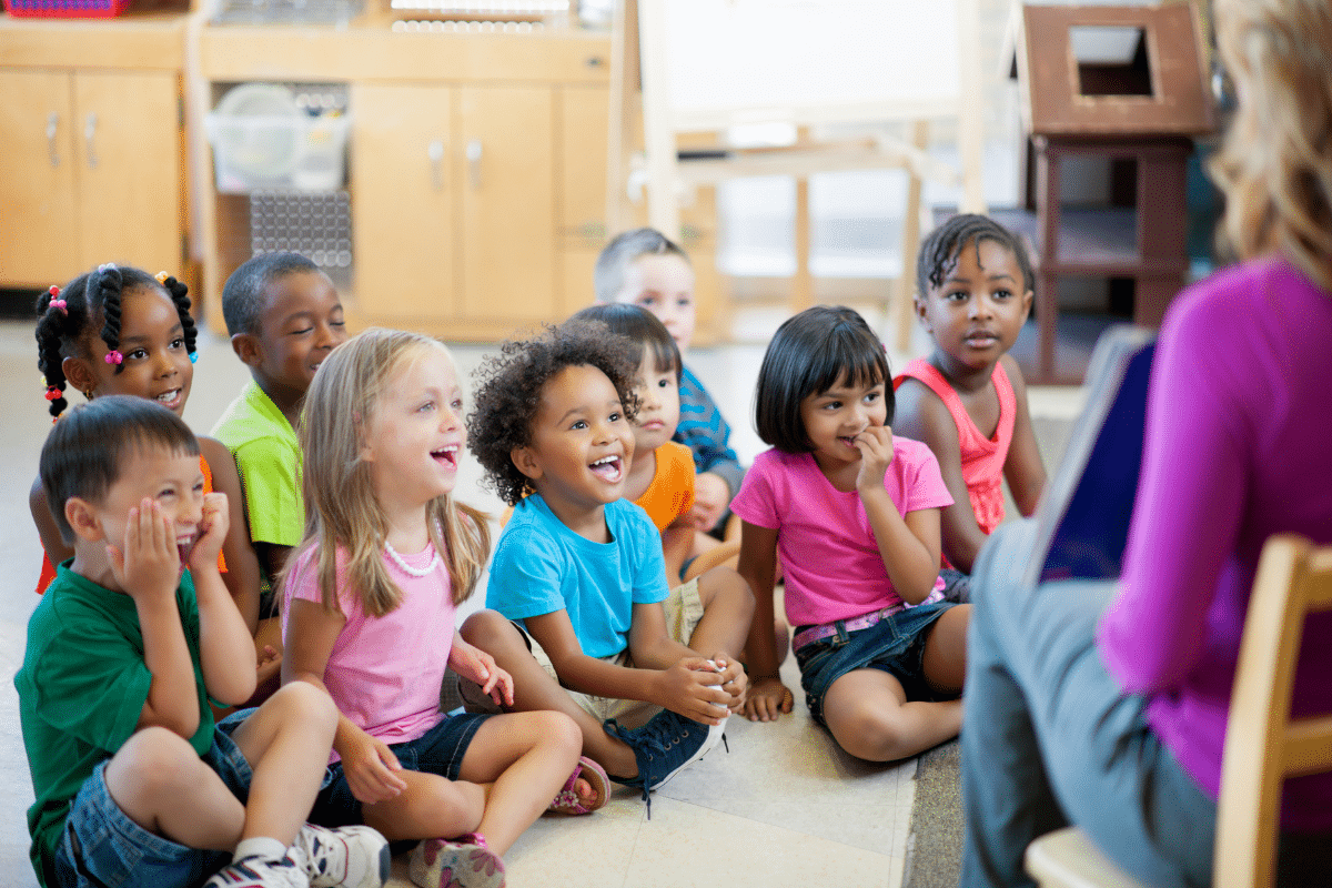 teacher reads to class of young children