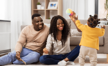 parents play with daughter in living room