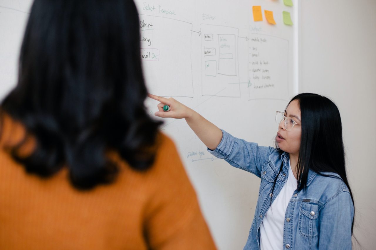 woman points to whiteboard