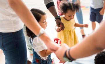 adults and toddlers holding hands