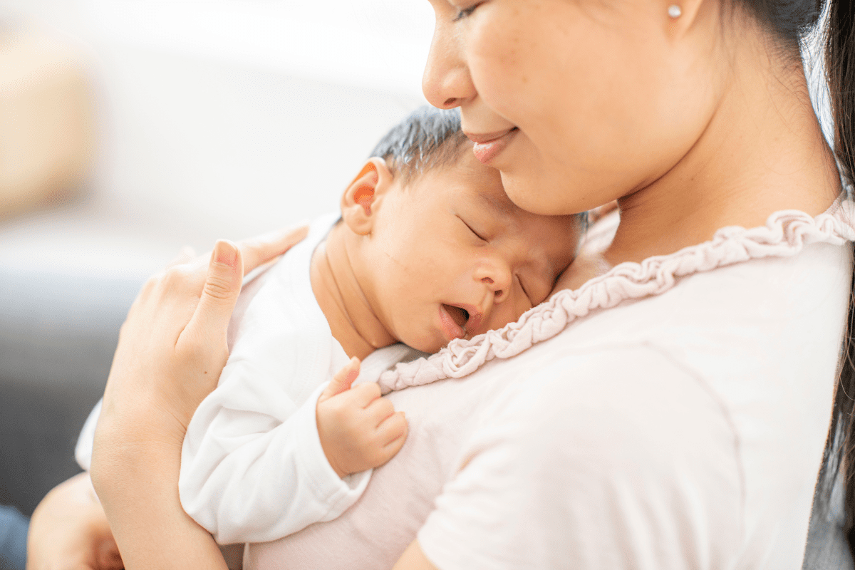 mom holds sleeping baby