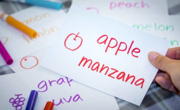 note with words apple and manzana written and a sketch of an apple