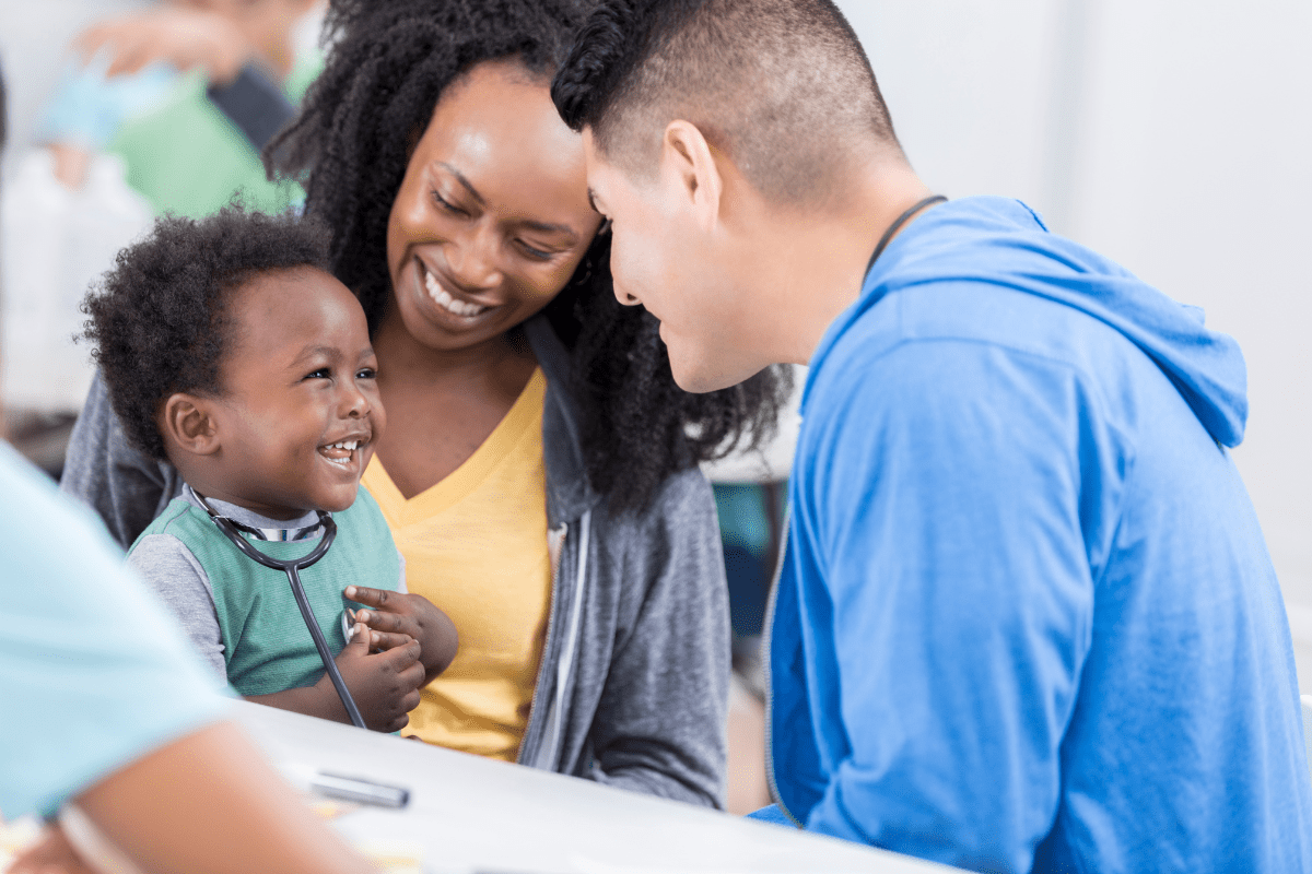 pediatric visit baby tries stethoscope