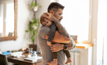 Man hugs son at home