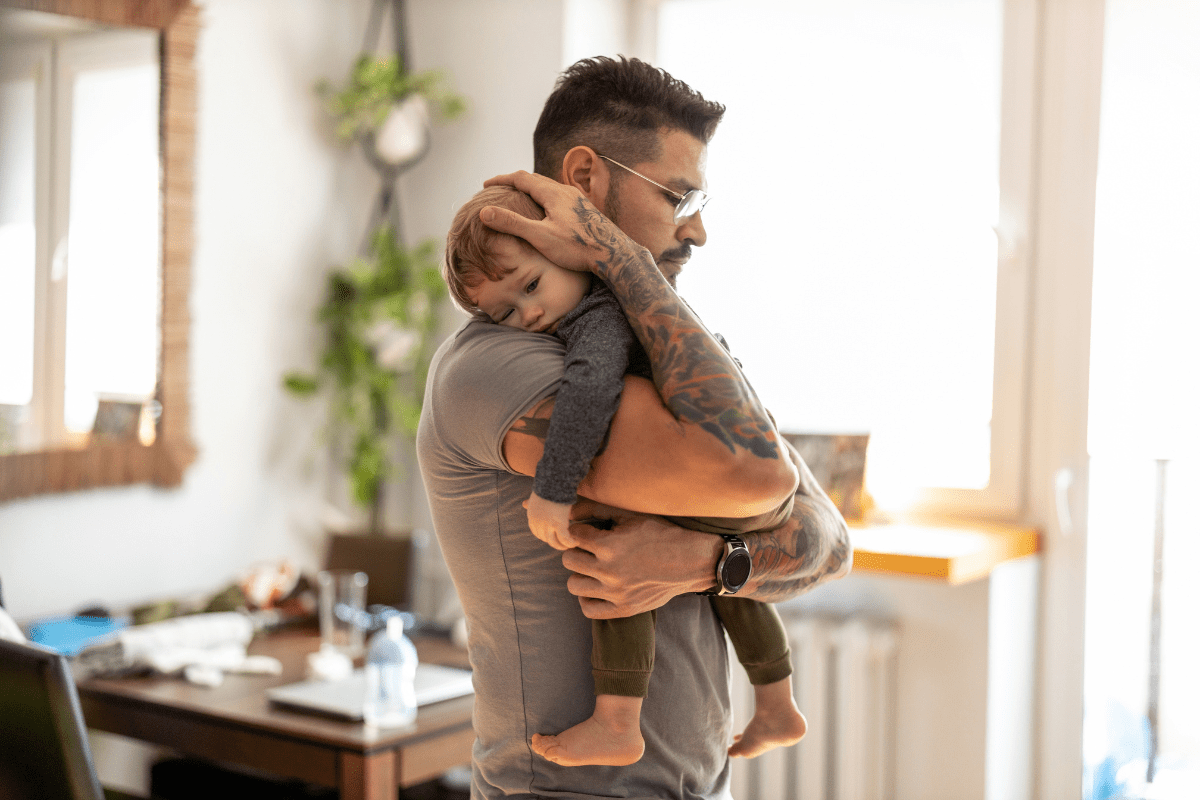 Man hugs son at home