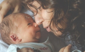 mom and infant nuzzle noses