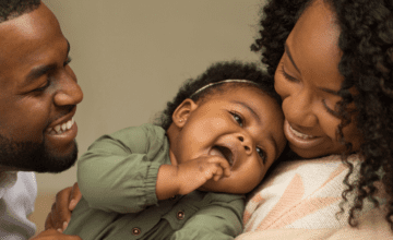 parents and baby laughing