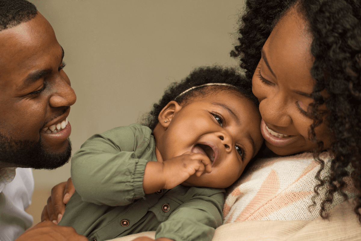 parents and baby laughing