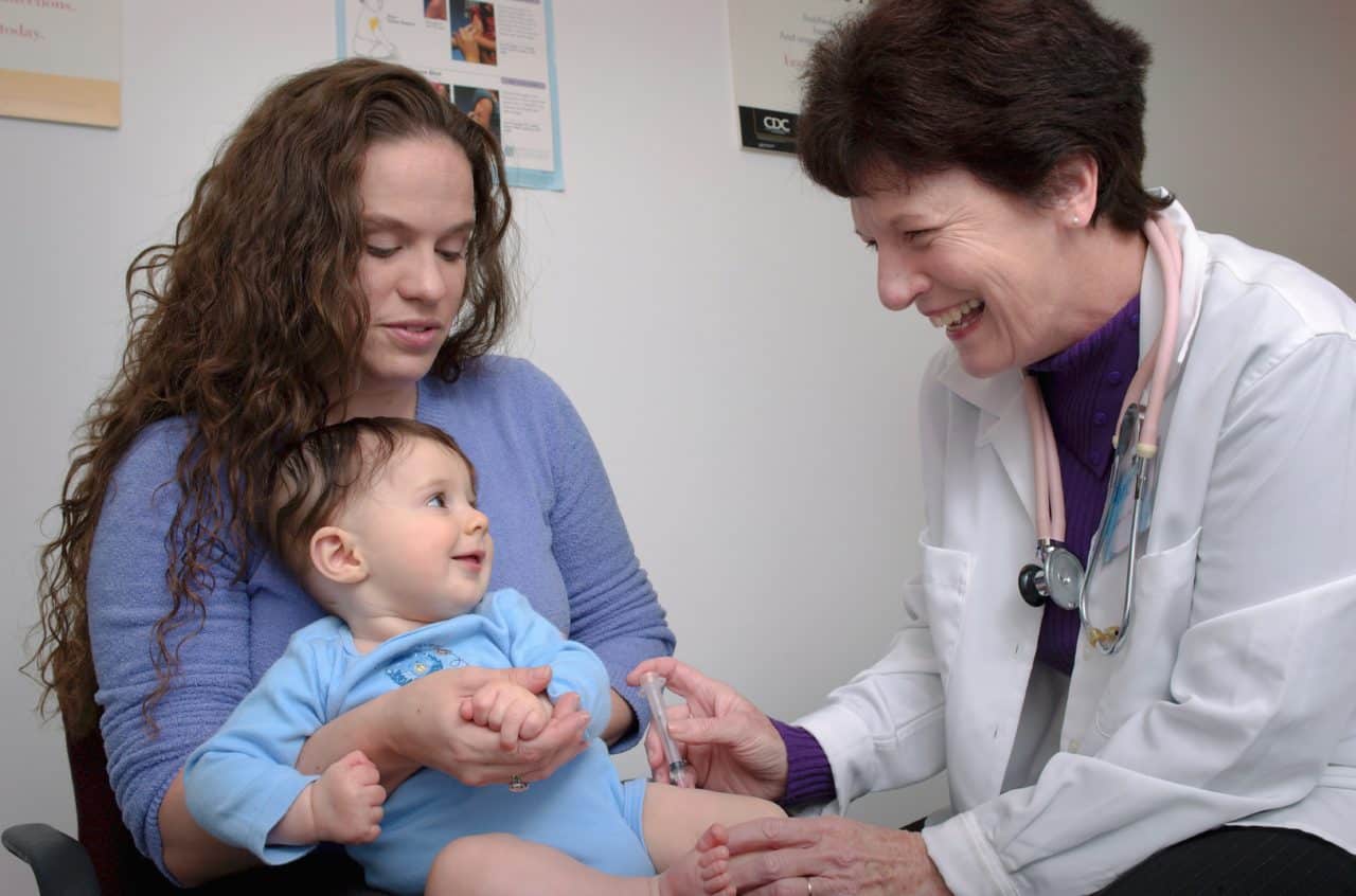 doctor gives shot to baby