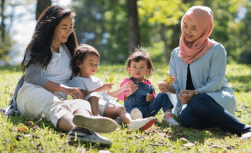 Two mothers with their children at a park