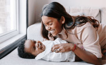 mom tickling baby laughing