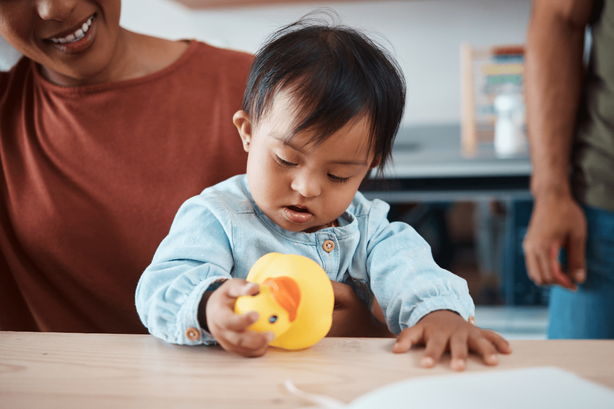 baby playing with rubber duck