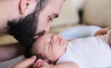 Father kissing baby forehead