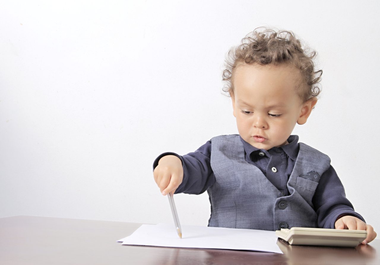 Toddler writing with ink pen