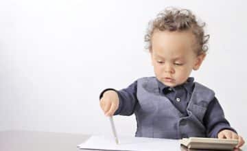 Toddler writing with ink pen