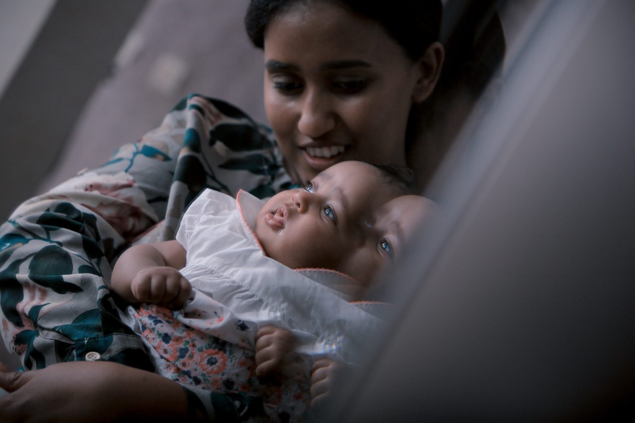 Smiling and holding baby